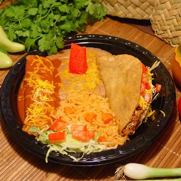 A Los Portales combo plate with an enchilada, taco, rice, and beans, garnished with cilantro and peppers.