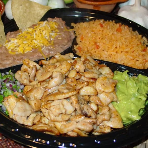 A Los Portales Taco Shop platter with chicken, rice, refried beans with cheese, guacamole, and pico de gallo.